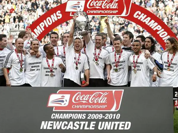 the_newcastle_united_squad_celebrate_with_the_trophy